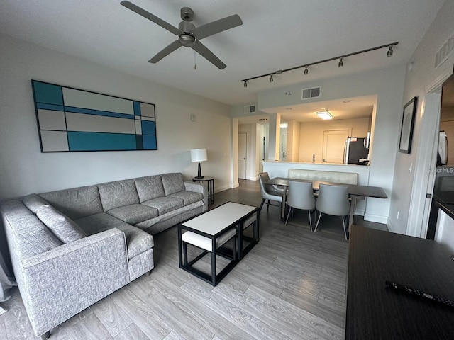 living room with hardwood / wood-style floors and ceiling fan