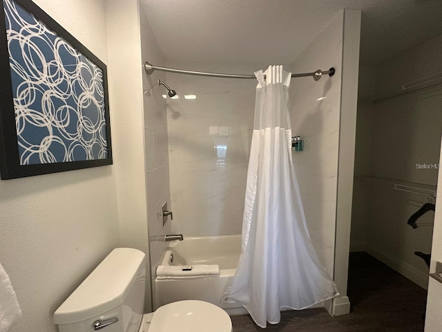 bathroom with toilet and shower / bath combo