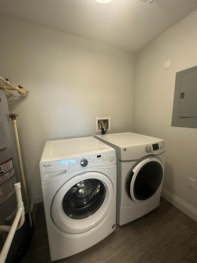 laundry room featuring washer and dryer, a textured ceiling, dark hardwood / wood-style flooring, electric panel, and water heater