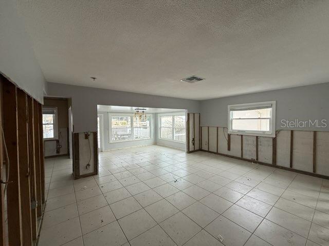 unfurnished room with a textured ceiling