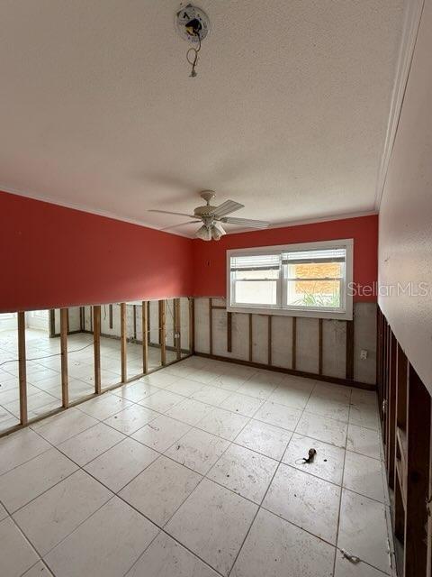 bonus room with a textured ceiling and ceiling fan