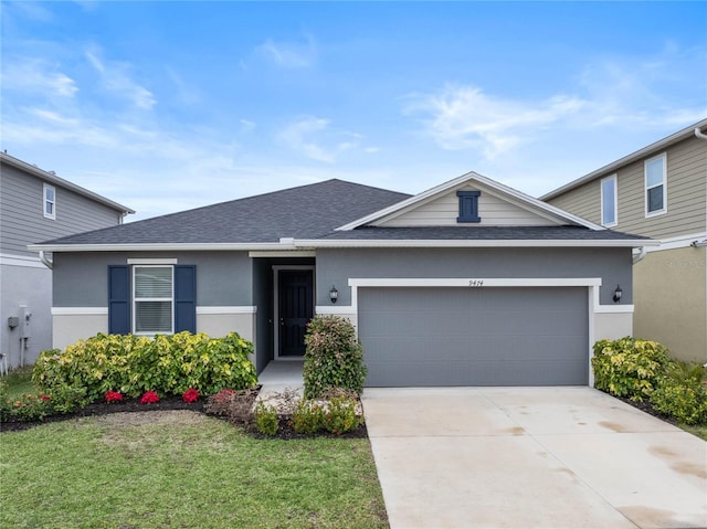 view of front of home with a front yard and a garage