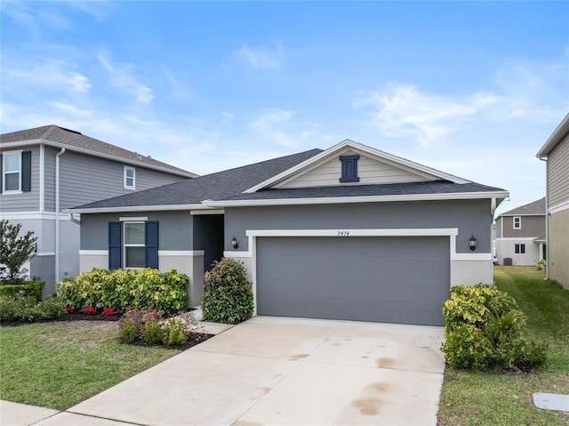 view of front of home featuring a front lawn and a garage