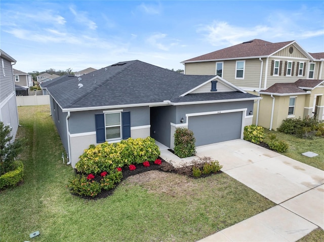 view of front of property featuring a garage and a front lawn