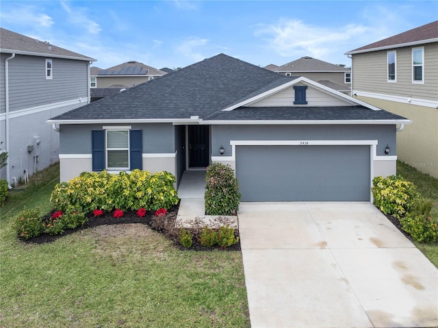 view of front facade with a front yard and a garage