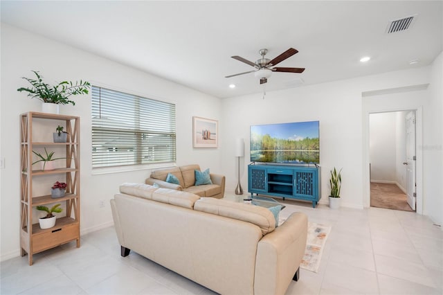 living room featuring ceiling fan and light tile patterned floors