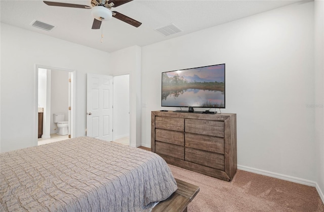 carpeted bedroom featuring ensuite bath and ceiling fan