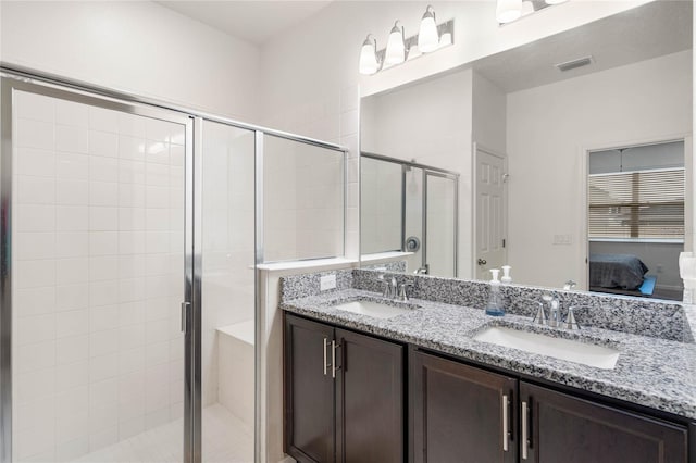 bathroom featuring vanity and a shower with door