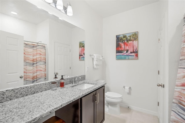 bathroom featuring tile patterned flooring, vanity, and toilet