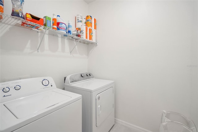 clothes washing area with washing machine and dryer