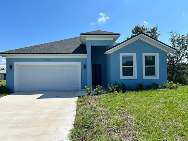 view of front of property featuring a garage and a front yard