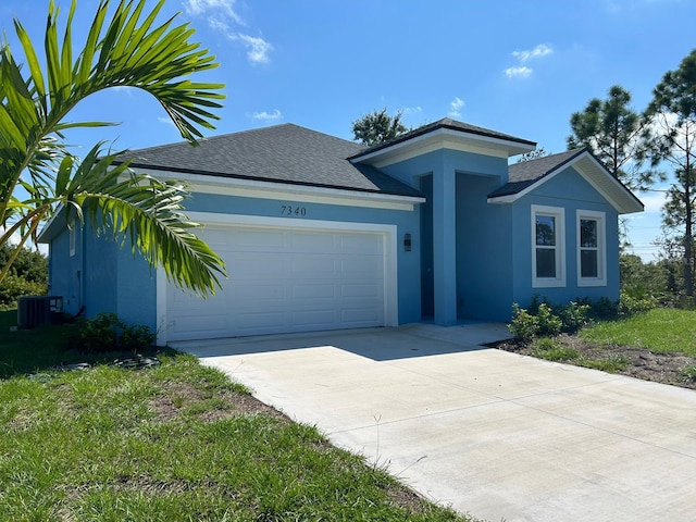 single story home with central AC and a garage