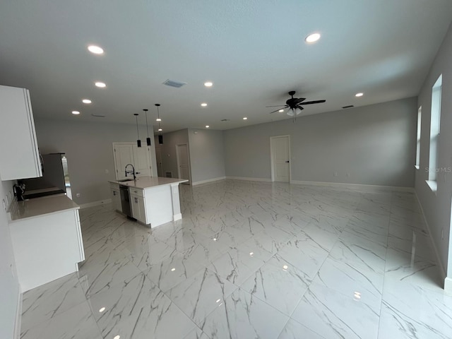 kitchen featuring pendant lighting, dishwasher, a center island with sink, sink, and white cabinetry