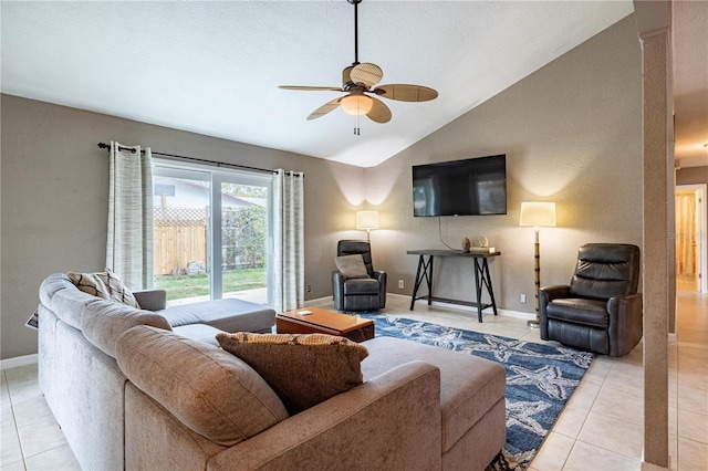 living room with lofted ceiling, ceiling fan, and light tile patterned floors