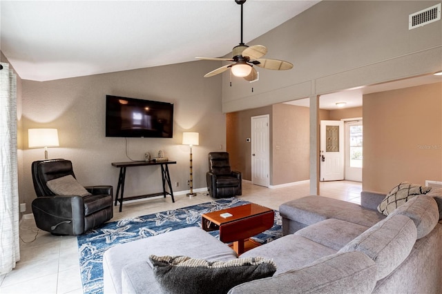 living room featuring lofted ceiling, ceiling fan, and light tile patterned floors