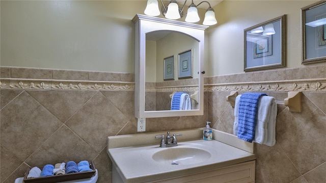 bathroom featuring sink, tile walls, and a notable chandelier