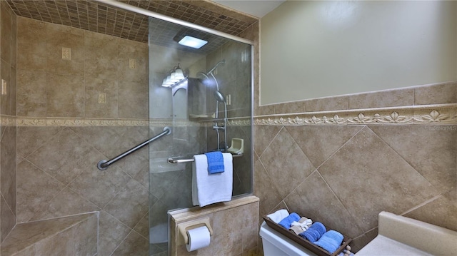 bathroom featuring toilet, an enclosed shower, and tile walls