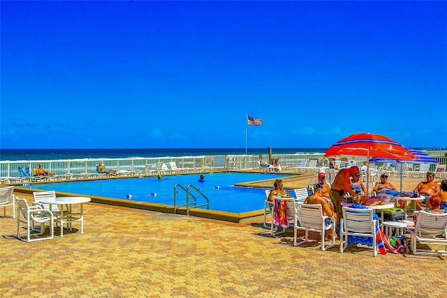 view of pool featuring a water view