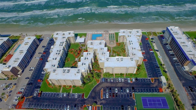 birds eye view of property featuring a water view and a beach view