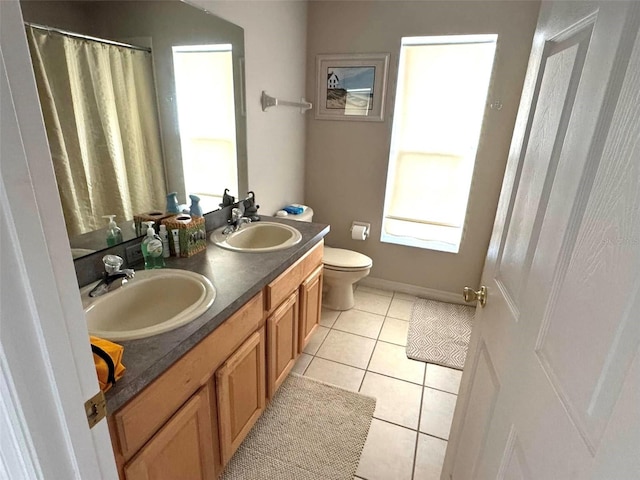 bathroom with toilet, tile patterned floors, and vanity