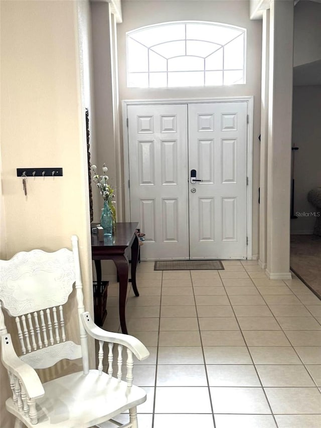 tiled entryway with a high ceiling