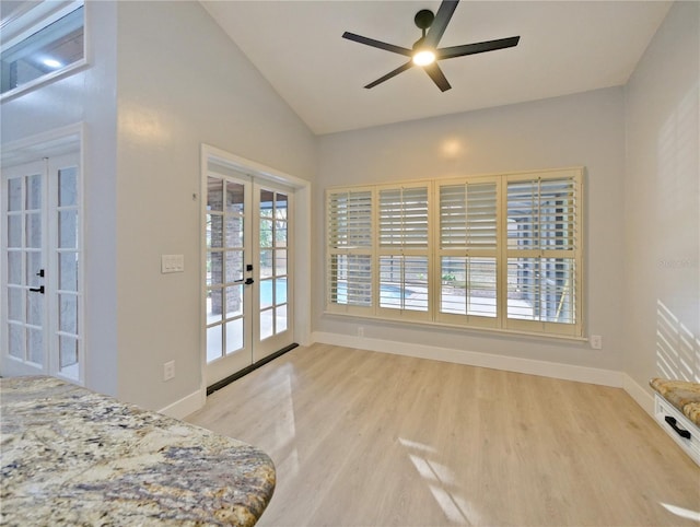 bedroom with french doors, vaulted ceiling, ceiling fan, access to exterior, and light wood-type flooring