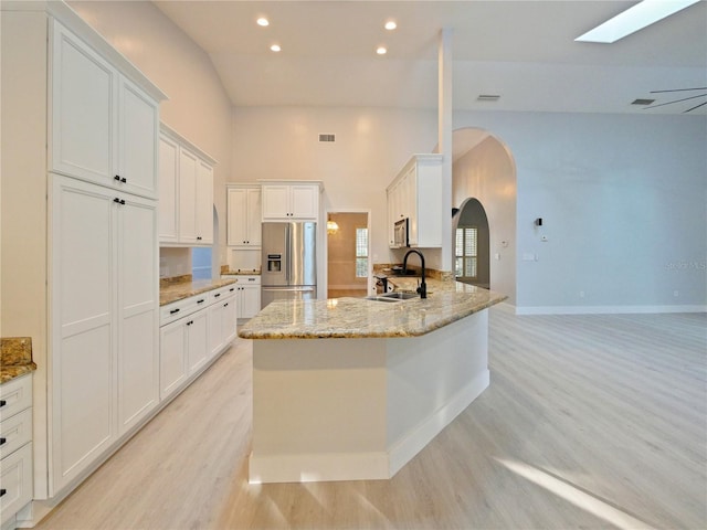 kitchen with sink, white cabinets, and stainless steel appliances