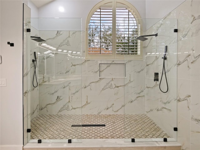 bathroom featuring a shower with shower door