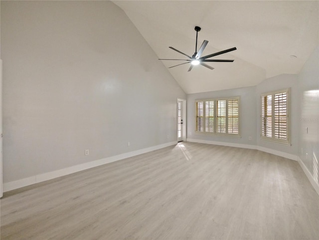 empty room featuring ceiling fan, high vaulted ceiling, and light wood-type flooring