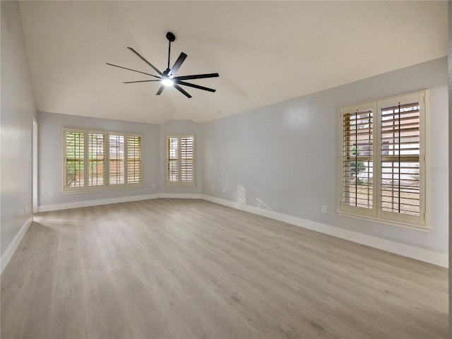 empty room with a wealth of natural light, light wood-type flooring, and ceiling fan