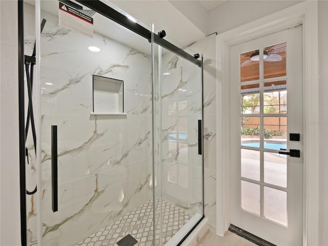 bathroom with a shower with door