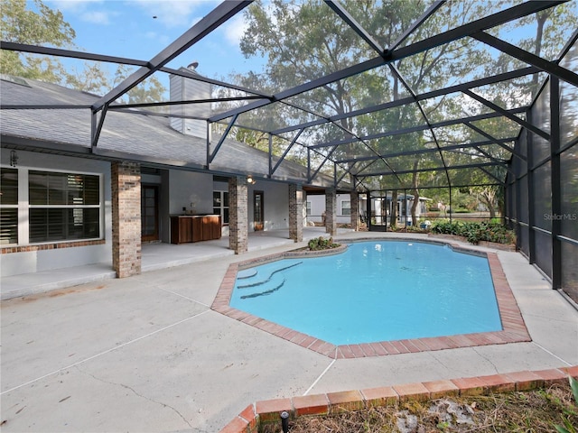 view of pool featuring a lanai and a patio