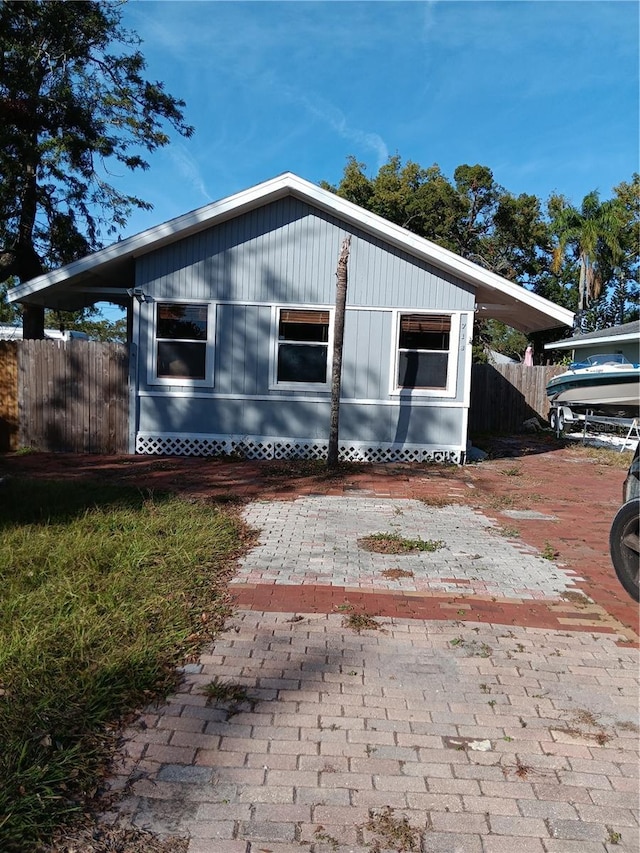 view of side of home featuring fence