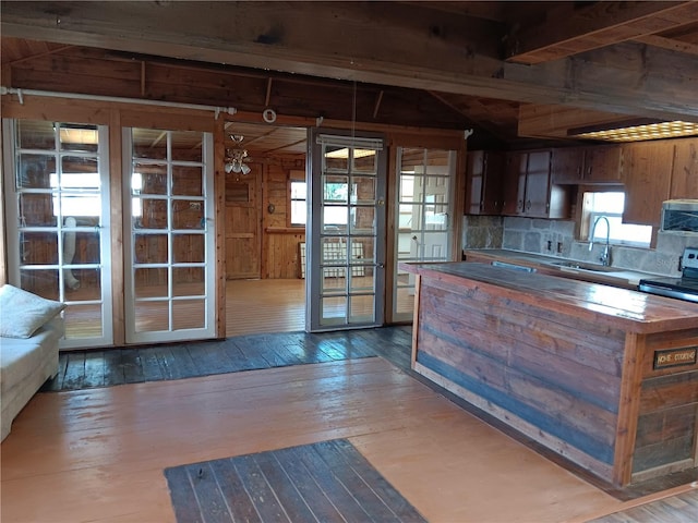 kitchen with hardwood / wood-style flooring, sink, and tasteful backsplash