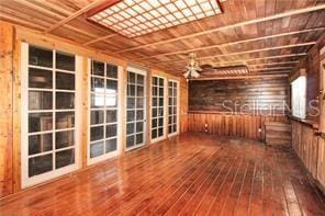 interior space featuring wood-type flooring and ceiling fan