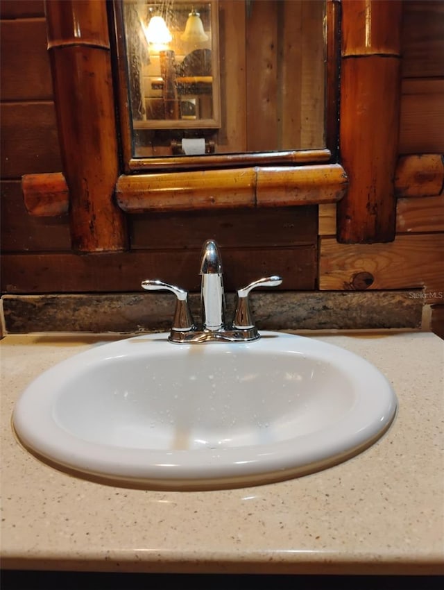 interior details with vanity, indoor wet bar, and wood walls