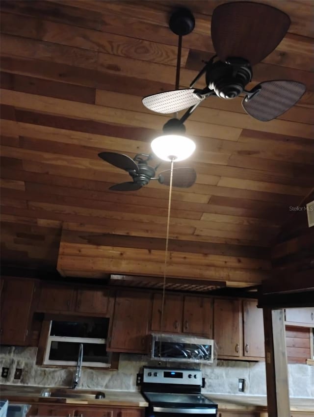 kitchen featuring appliances with stainless steel finishes, wooden ceiling, backsplash, and ceiling fan