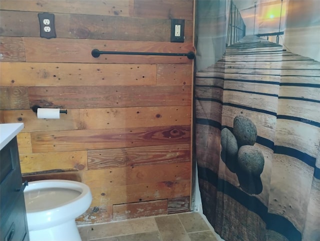 718 New York St, Clearwater, FL 33756 - full bath featuring wood walls, stone finish floors, and vanity