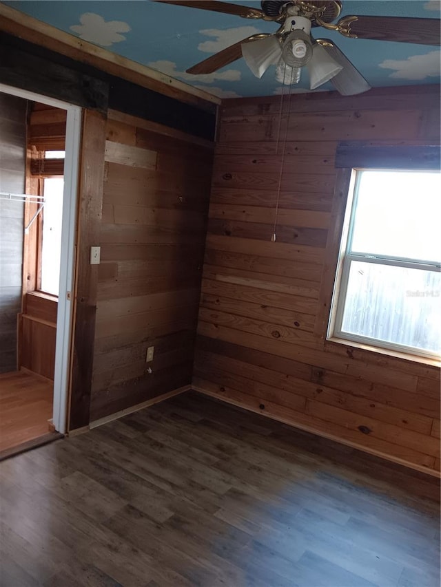 718 New York St, Clearwater, FL 33756 - spare room featuring wood walls, dark wood-style flooring, and ceiling fan