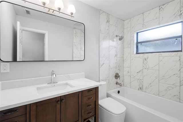 full bathroom with vanity, toilet, and tiled shower / bath