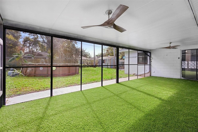 unfurnished sunroom featuring ceiling fan