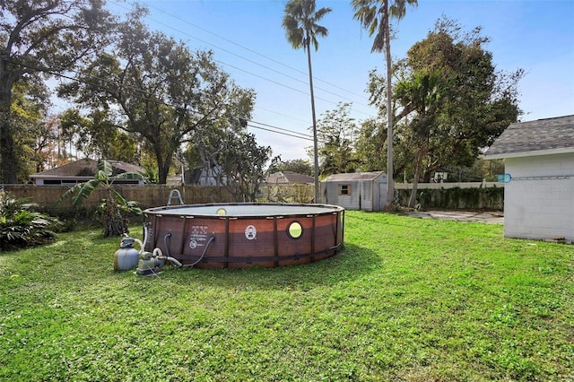 view of yard with a fenced in pool and a storage shed