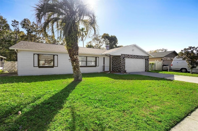 ranch-style home featuring a garage and a front lawn