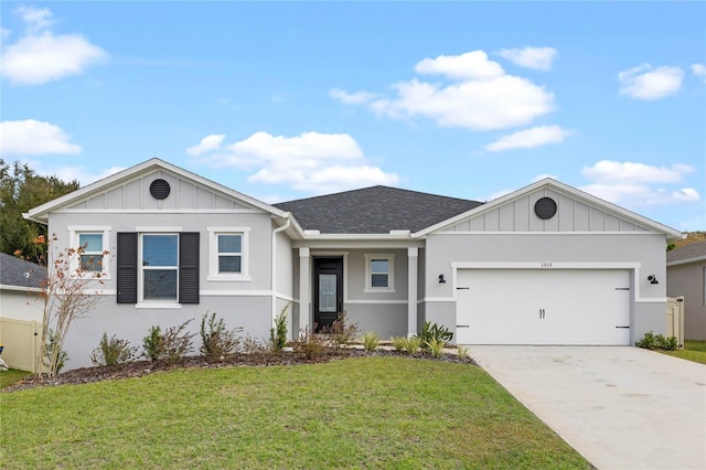 view of front of home featuring a front yard and a garage