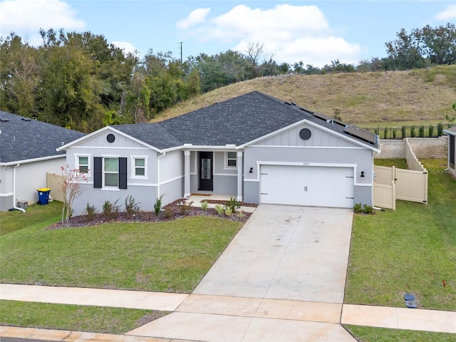 single story home with a garage and a front lawn