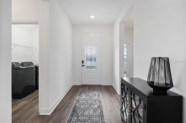 foyer entrance with dark hardwood / wood-style flooring and washer and clothes dryer