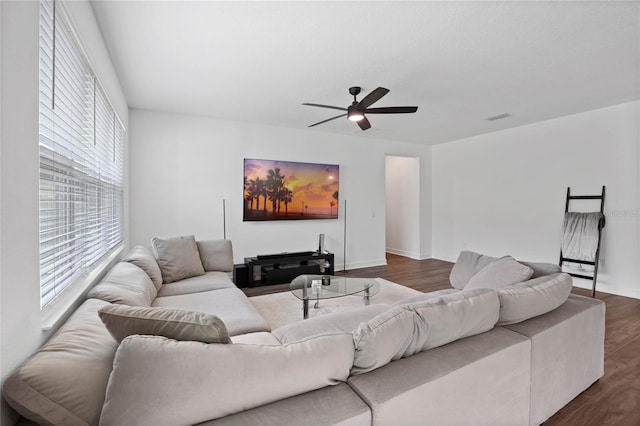 living room with ceiling fan and dark wood-type flooring