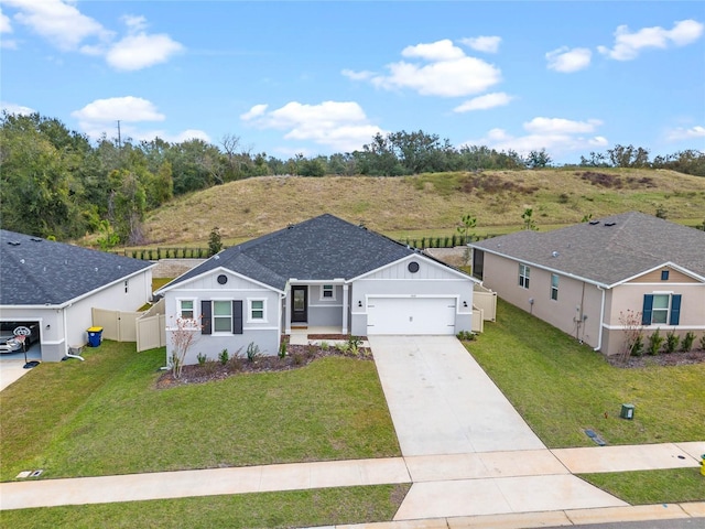 ranch-style house with a garage and a front lawn