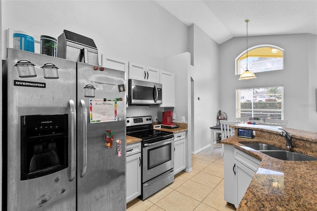 kitchen with light tile patterned floors, white cabinetry, stainless steel appliances, and a sink