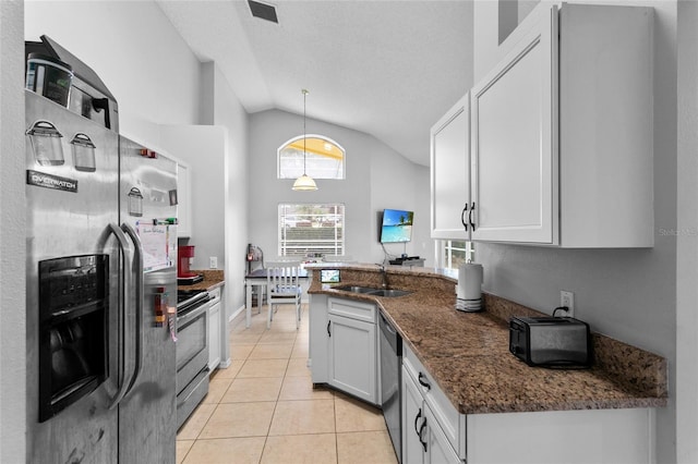 kitchen featuring visible vents, a peninsula, light tile patterned flooring, a sink, and appliances with stainless steel finishes